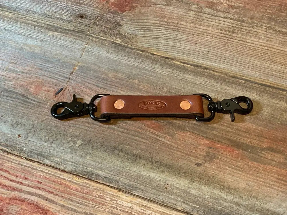 Brown leather anti-sway strap with metal clasps for radio strap combos