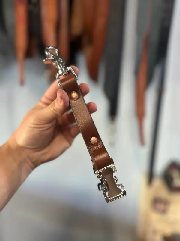 Brown leather firefighter glove strap with metal clasps, ideal for first responders and police