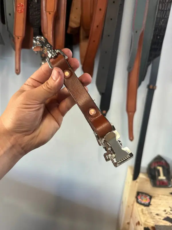 Brown leather firefighter police glove strap with metal hardware for quick release and durability
