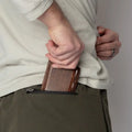 Brown leather wallet with concealed carry design in Carrier Traveler Joggers featuring carrier retention waistband
