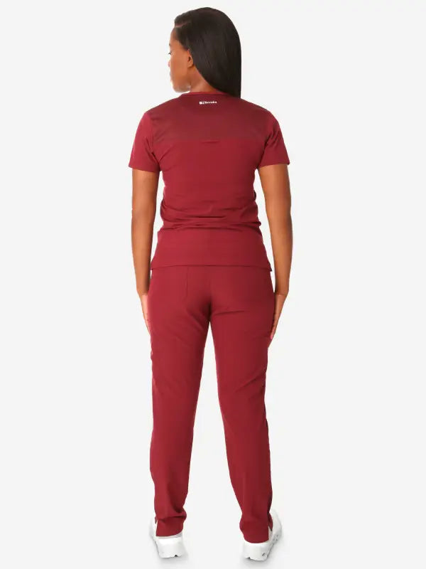 Burgundy athletic jumpsuit back view featuring Women’s Tuckable One-Pocket design