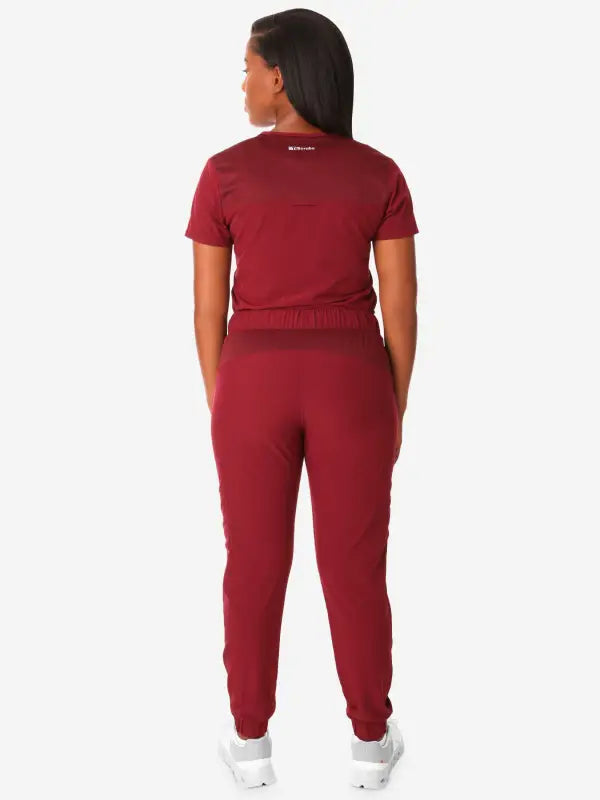 Burgundy athletic jumpsuit back view, highlighting Women’s Tuckable One-Pocket design