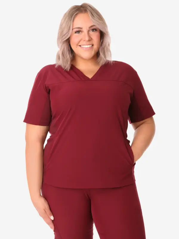 Burgundy women’s stash-pocket scrub top with v-neck and short sleeves