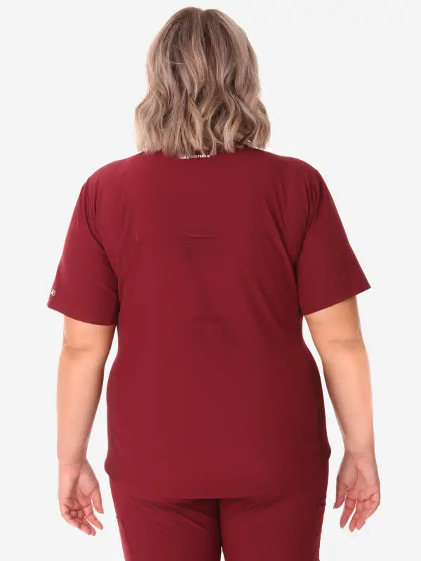 Burgundy women’s stash-pocket scrub top viewed from the back for comfort and style