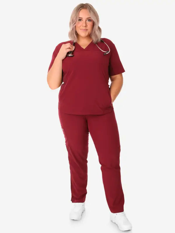 Burgundy women’s stash-pocket scrub uniform with v-neck top and matching pants