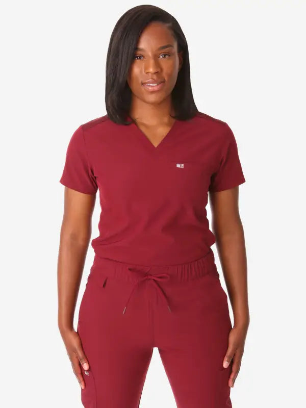 Burgundy Women’s Tuckable One-Pocket Scrub Top with matching pants for medical professionals