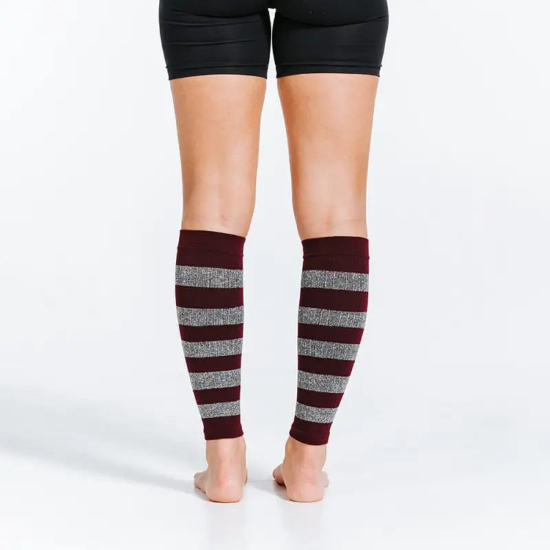 Burgundy and silver striped calf compression sleeves over bare legs with heather stripes