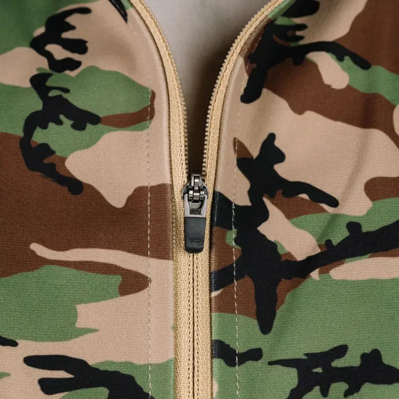 Camouflage jacket with zipper showcasing durable quarter zip design for outdoor wear