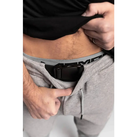 Concealed carry holster in gray pants featuring Carrier Rapid Clasp Retention Belt