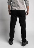 Black straight-leg jeans paired with a grey top showcasing Carrier Sweatpants - Midnight Black