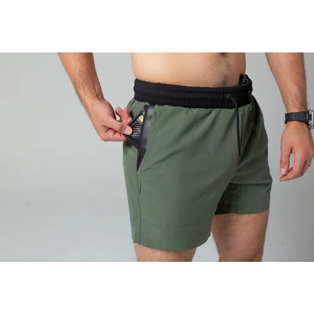 Olive green Carrier Training Shorts with black waistband and side pocket for concealed carry