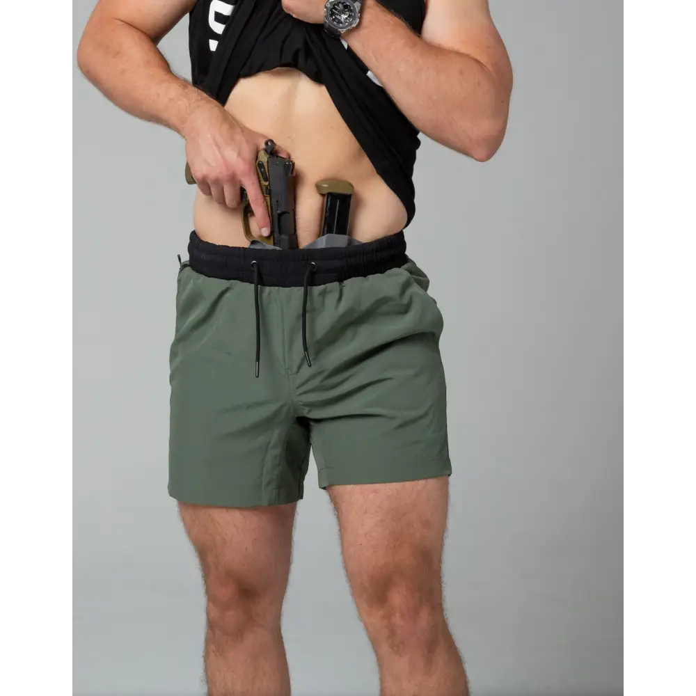 Concealed carry holster with handgun in Carrier Training Shorts - Ranger Green 5 inches