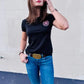 Casual outfit showcasing Woman’s Midnight Tee with logo patch and blue jeans