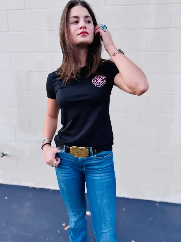 Casual outfit showcasing Woman’s Midnight Tee with logo patch and blue jeans