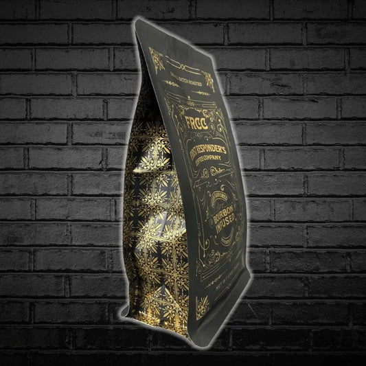 Illuminated black menu stand showcasing 12oz Bourbon Infused Coffee with gold patterns