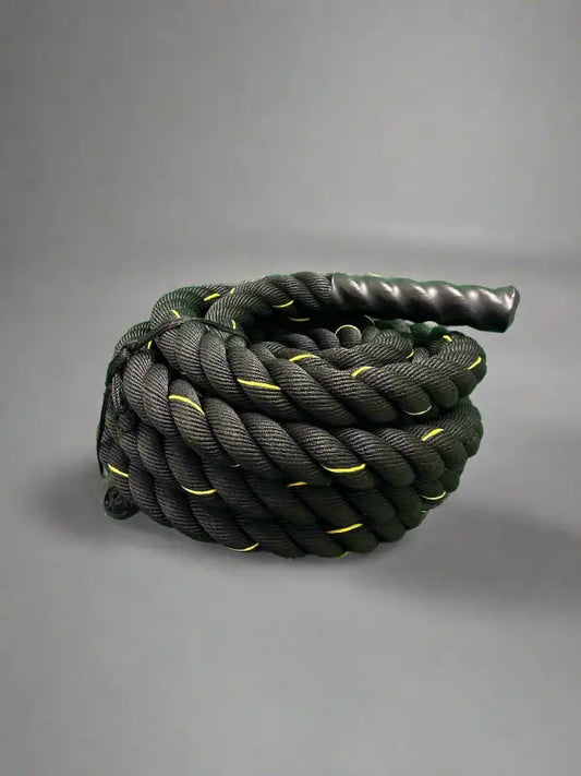 Coiled black firefighter battle rope with yellow accents and textured handle for first responders