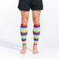 Colorful striped calf compression sleeves worn on bare legs with black shorts