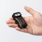 Compact black Wuben X3 Beacon All-in-One Flashlight + Charging Dock held in hand