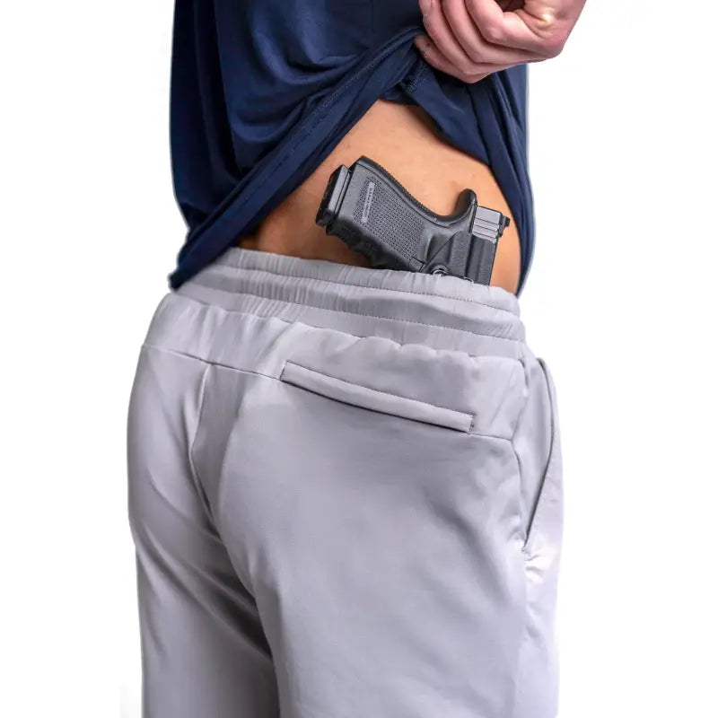 Concealed handgun in waistband of Carrier Shorts - Chalk Grey 11 with patented carrier retention