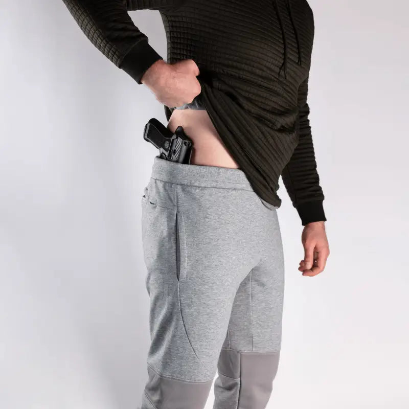 Concealed handgun in waistband of Carrier Joggers Mk.II for concealed carry and carrier retention