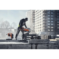 Construction worker using Husqvarna K 1 PACE battery powered rescue power cutter on rooftop