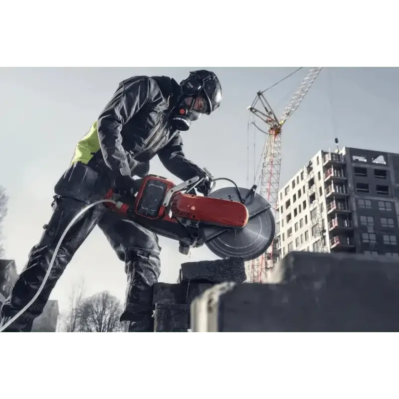 Construction worker using Husqvarna K 1 PACE rescue power cutter for concrete cutting