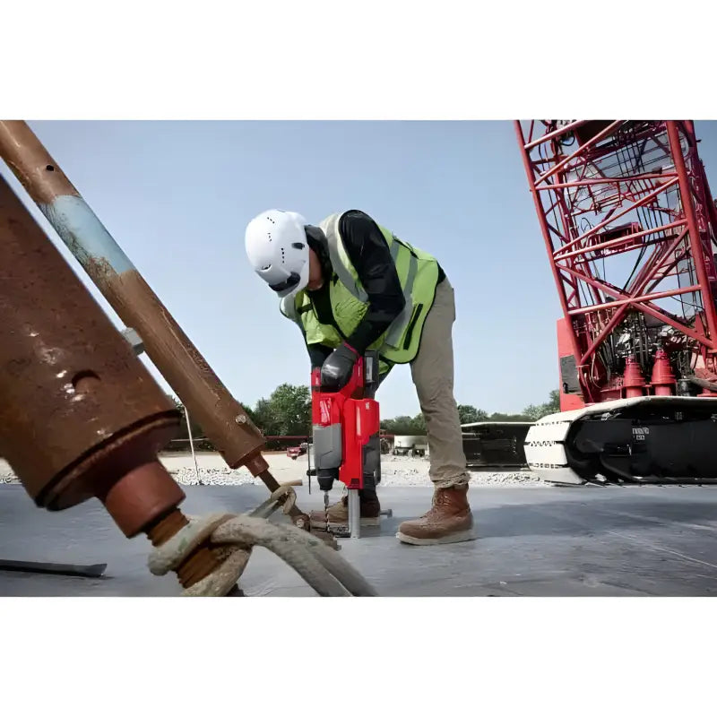 Construction worker using Milwaukee 2916-20 M18 FUEL 1-1/4 D-Handle Rotary Hammer on concrete