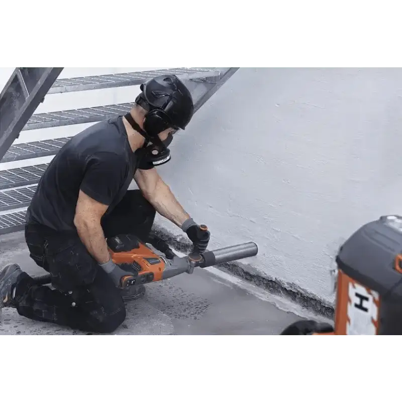 Construction worker using Husqvarna 540i battery powered core drill kit on concrete flooring