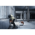 Construction worker using Husqvarna 540i battery powered core drill kit on a wall