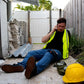 Construction worker in safety vest using The First Responder IFAK Kit while on phone