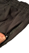 Dark Cotton Joggers- Equipped with zipper detail held by a hand for stylish comfort