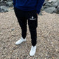 Black Cotton Joggers- Equipped with white logo paired with stylish white sneakers