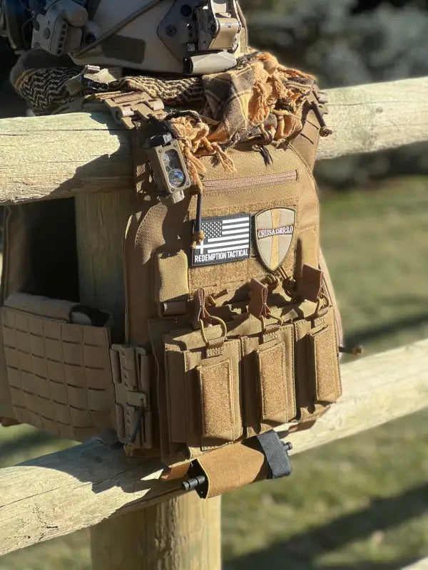 Coyote brown tactical vest with patches including American flag and Redemption Tactical medical kit body armor