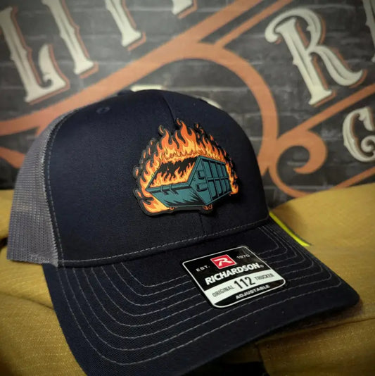 Dark blue baseball cap with firefighter dumpster fire patch and leather patch for first responders
