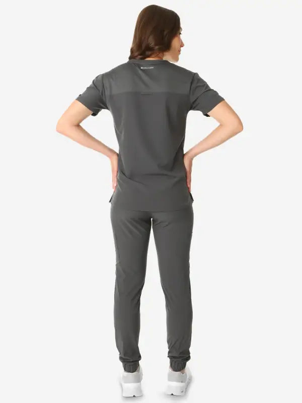 Dark gray women’s tuckable one-pocket scrub uniform with short sleeves and fitted pants