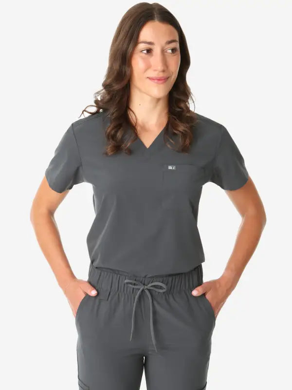 Dark gray women’s tuckable one-pocket scrub top with v-neck and drawstring pants