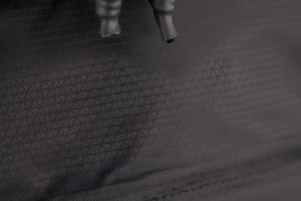 Dark textured fabric with geometric pattern on SUMMIT Discreet Rifle Backpack