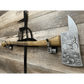 Decorative personalized axe with engraved blade and rustic handle mounted on brackets