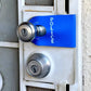 Door handle with blue POLICE tag on a POLICE DoorJamm for first responders