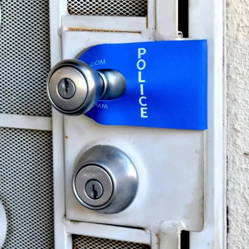 Door handle with blue POLICE tag on a POLICE DoorJamm for first responders