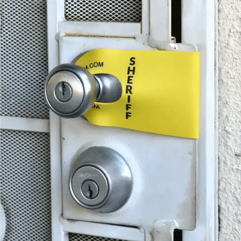 Door handle with yellow SHERIFF tag, part of Sheriff DoorJamm for first responders