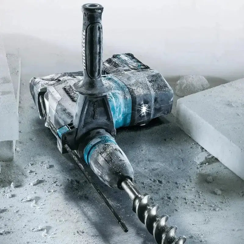 Dusty Makita GRH05M1 XGT® Brushless AVT® Rotary Hammer with drill bit attached