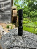 Black Tactical EDC Flashlight on Weathered Wood, Powertac E9 GEN5 3000 Lumen