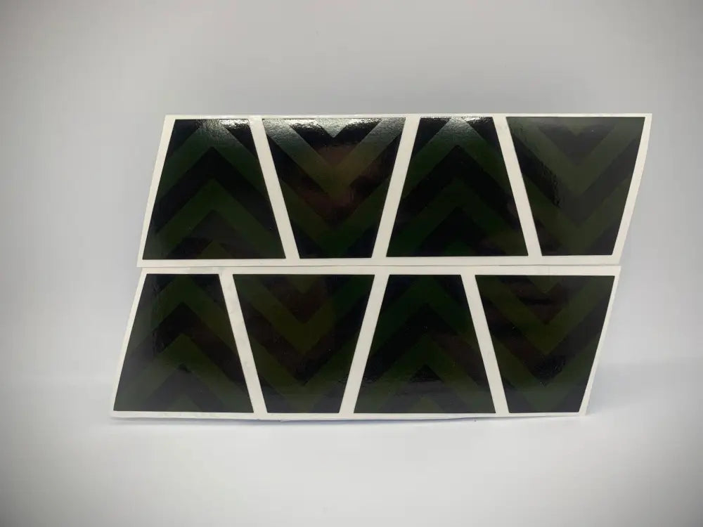 Eight black triangular shapes with white borders in a Yellow Chevron Reflective Helmet pack