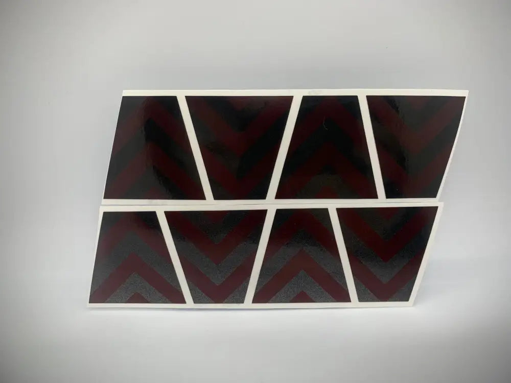 Eight dark triangular panels with white borders in the BLACKED OUT RED CHEVRON REFLECTIVE HELMET