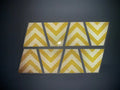 Eight yellow chevron reflective tiles in a pattern for the Chevron Reflective Helmet