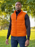 Orange quilted puffer vest over black sweater from Equinoxx Stage 3 collection