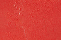 Water droplets on a red surface of Firefighter Jumbo Turnout Gear Bag with Reflective Trim