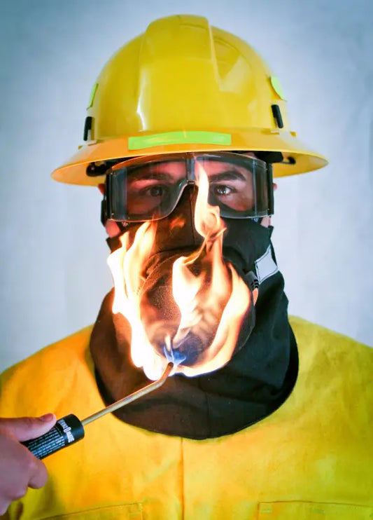 Firefighter wearing protective gear with flames using Hot Shield® HS-4 mask for Sundstrom SR-100 half face respirator