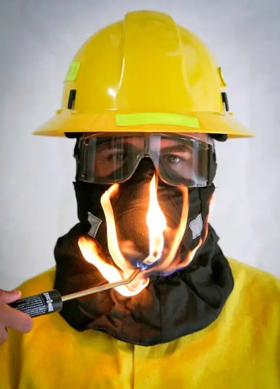 Firefighter in protective gear with flames showcasing Hot Shield® HS-2 Wildland Firefighter Face Mask for ash particulate protection
